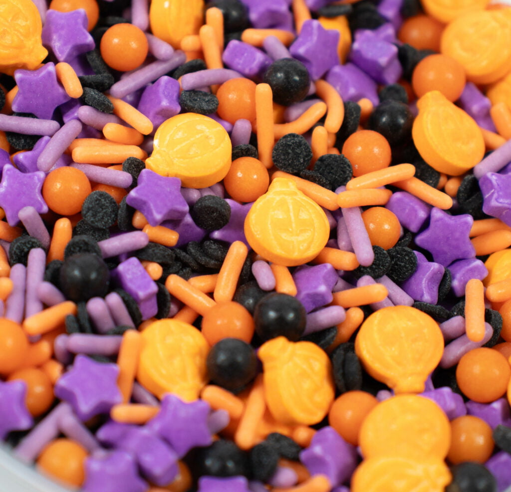 Sprinkles Halloween in a bowl with purple, orange, and black sprinkles.
